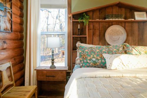 a bedroom with a bed and a window at 15 Mins to U of A - Pool & Hot Tub in Fayetteville