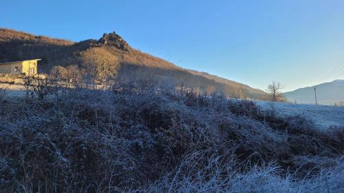 a field covered in snow with a mountain in the background at LES CHALETS de MONTORGUEIL in Saurat