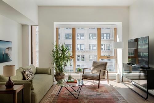 a living room with a couch and a table at ROOST White House in Washington