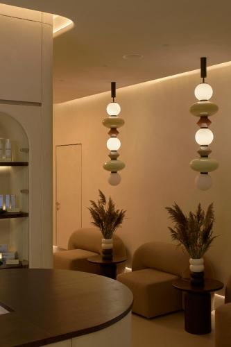 a living room with a table and pendant lights at Mana Suites & Sea SPA in Palanga