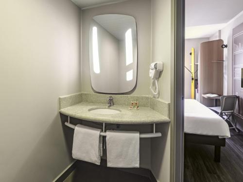 a bathroom with a sink and a mirror at ibis Sao Paulo Ibirapuera in Sao Paulo