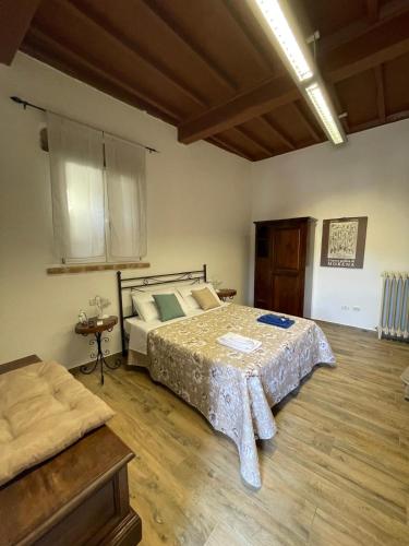 a bedroom with a bed and a table in it at Palazzo Marini in Spoleto
