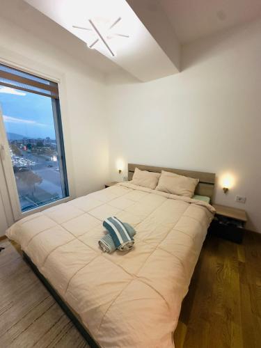 a large bed in a room with a large window at Dream Holiday Apartments in Skopje