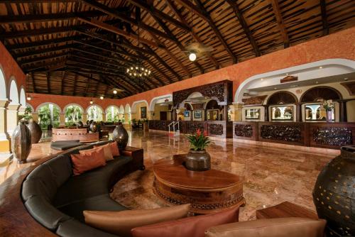 a living room with a couch and a table at Iberostar Waves Paraíso Beach - All Inclusive in Puerto Morelos