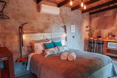 a bedroom with a bed with two pairs of shoes on it at Chalé Climatizado, com banheira e varanda em frente ao Parque do Passaúna em Curitiba by Tiny House Passaúna in Curitiba