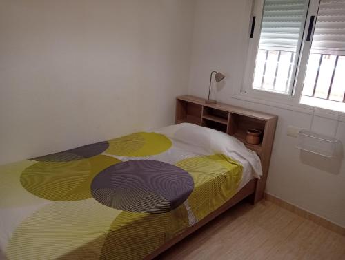 a bedroom with a bed with a colorful comforter at Oropesa summer in Oropesa del Mar