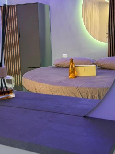 a room with two beds with a sign on it at SN Luxury Room & Spa in Foggia