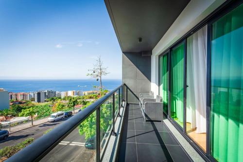 a balcony of a building with a view of the ocean at Leonor Seaview Apartment in Funchal