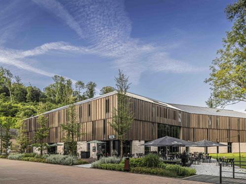 a rendering of a large wooden building at Hotel Valkenburg by Mercure - Next to Shimano Experience Center in Valkenburg