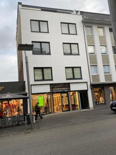a large white building with windows on a street at Chris Home - Mönchengladbach Minto in Mönchengladbach