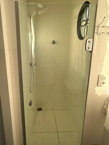 a bathroom with a shower with a tiled floor at Casa aconchegante Barroca in Belo Horizonte