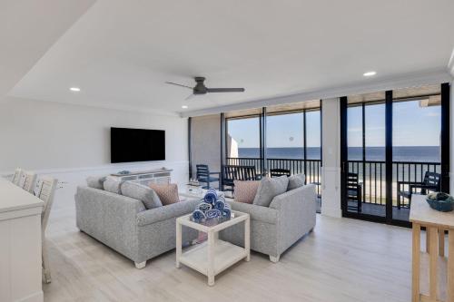 a living room with a view of the ocean at Sundial K402 - Executive Beach View Two Bedroom Penthouse at Sundial Sanibel in Sanibel
