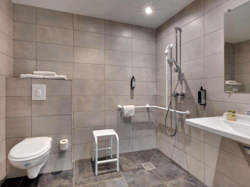 a bathroom with a toilet and a sink at Hotel Ibis Budget Montpellier Centre Millenaire - in Montpellier