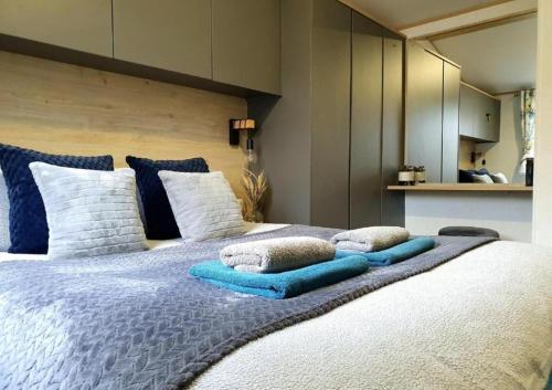 a bedroom with a large bed with pillows on it at The Treehouse Northumberland in Swarland