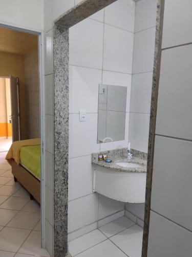 a bathroom with a sink and a mirror at Amazônia Praia Hotel in Tibau