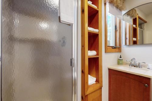 a bathroom with a stainless steel refrigerator and a sink at Bayside Sunshine in Freedom