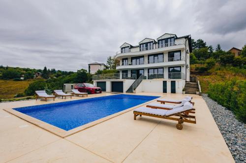 a large house with a swimming pool in front of it at Green panorama Vrdnik in Vrdnik