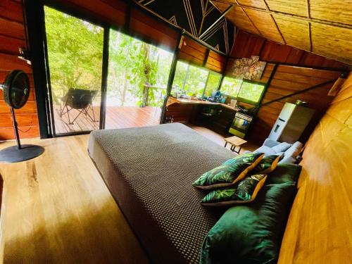 a bedroom with a large bed in a tree house at Cabaña Río San Carlos Ecolodge in Boca Tapada