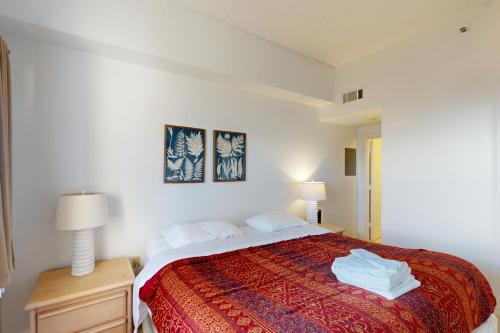 a bedroom with a large bed with a red blanket at Citadel 3626 in Sugar Mountain