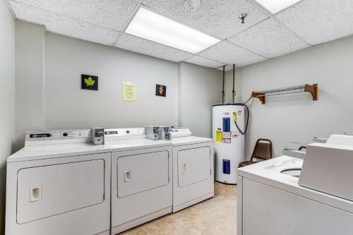 a kitchen with white appliances and a refrigerator at Citadel 3626 in Sugar Mountain
