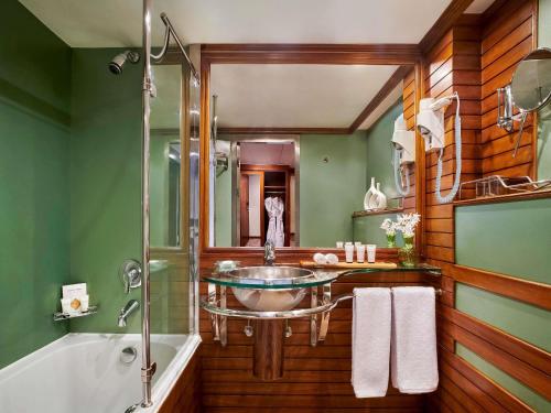 a bathroom with a sink and a bath tub at Mövenpick Royal Lotus Nile Cruise, Every Monday Four Nights From Luxor, Every Friday Three Nights From Aswan - Including Excursions & Sightseeing in Luxor