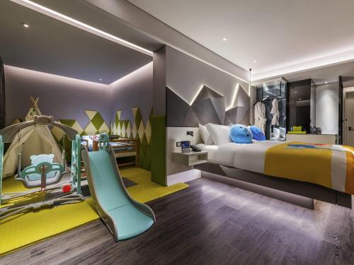 a childrens bedroom with a bed and a slide at Novotel Yangzhou City Center in Yangzhou