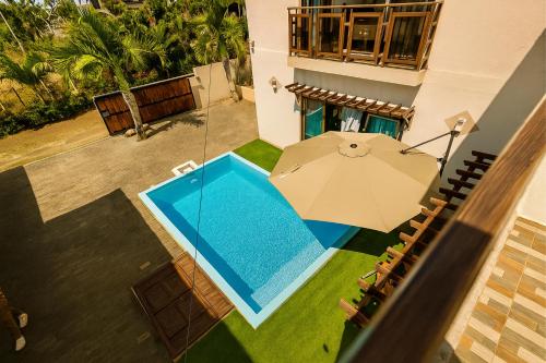 an overhead view of a house with an umbrella and a swimming pool at Hope Villa in Calodyne