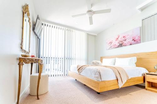 a bedroom with a bed and a ceiling fan at 412 on CODA Oasis with Mountain View in Coffs Harbour