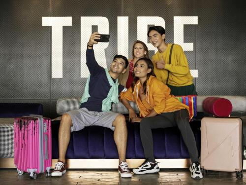 a group of people sitting on a couch taking a picture at TRIBE Phnom Penh Post Office in Phnom Penh