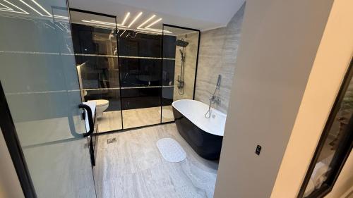 a bathroom with a bath tub and a toilet at Villa from Al Essam Development with private pool, jacuzzi and home cinema المجلس من ال عصام للتطوير مع المسبح والجاكوزي الخاص والهوم سينما in 6th Of October