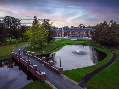 a large building with a pond in front of it at Fairmont Windsor Park in Windsor
