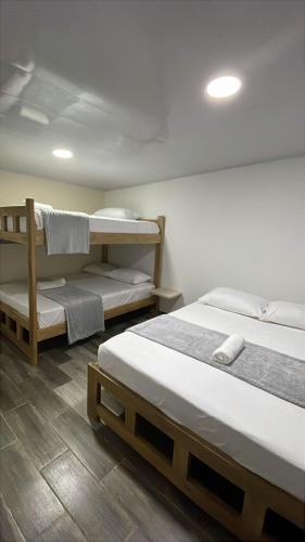two beds in a room with two bunk beds at Hotel Casablanca in Galapa
