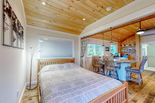 a bedroom with a bed and a kitchen with a table at Riverbank Place in Moody