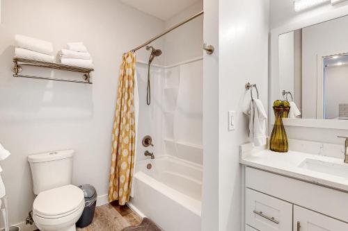 a bathroom with a toilet and a sink and a shower at Serenity of Belltown Court in Seattle
