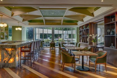 a restaurant with tables and chairs and a fireplace at Sheraton Maria Isabel Mexico City Reforma in Mexico City