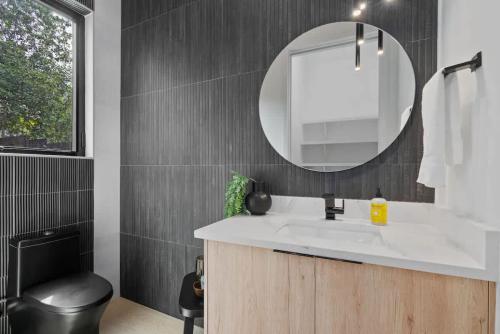 a bathroom with a white sink and a mirror at Heated Pool Luxury Zilker home Sleeps 8 great view in Austin