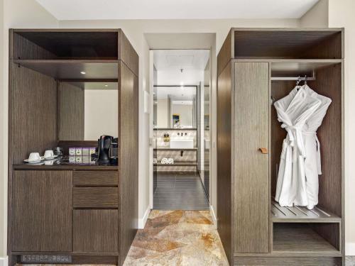 a dressing room with a wedding dress on a hanger at Peppers Docklands in Melbourne