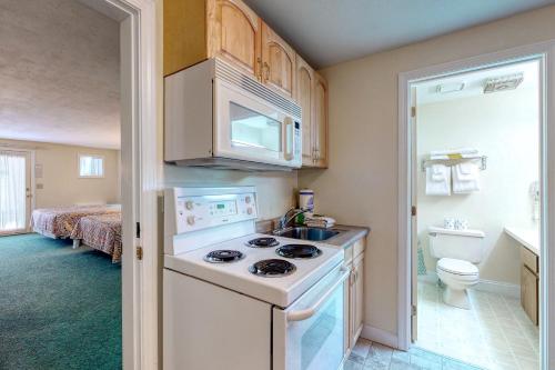 a small kitchen with a stove and a sink at Seafarer Resort-Unit 107 in Ogunquit