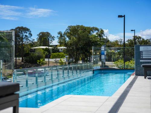 a swimming pool with a fence around it at Mantra Gladstone in Gladstone