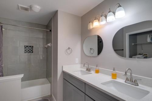 a white bathroom with two sinks and a shower at Family Home Near UMD and Dtwn Silver Spring! in Adelphi