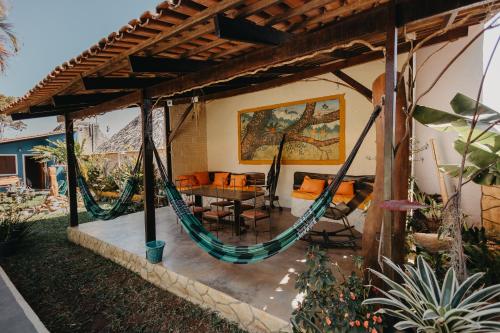 a patio with a hammock in a house at Pousada Casa do Cerrado - Alto Paraíso de Goiás in Alto Paraíso de Goiás