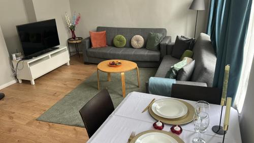 a living room with a couch and a table at Appartement diamant in Brussels