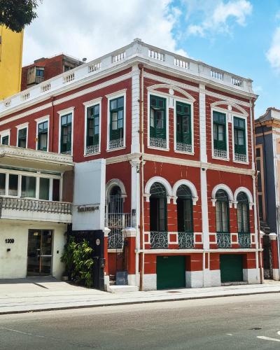 a red building on the side of a street at JUNGLE STATION - Hostel in Belém