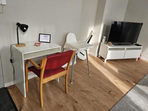 a room with a desk with a computer and a table with a chair at Appartement diamant in Brussels