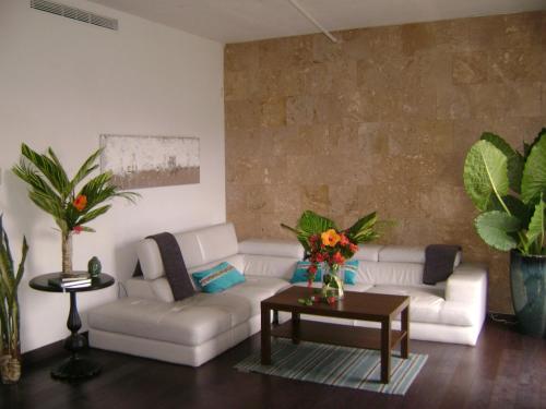 a living room with a white couch and a table at Zen Retreat City Center Near Train in San Juan