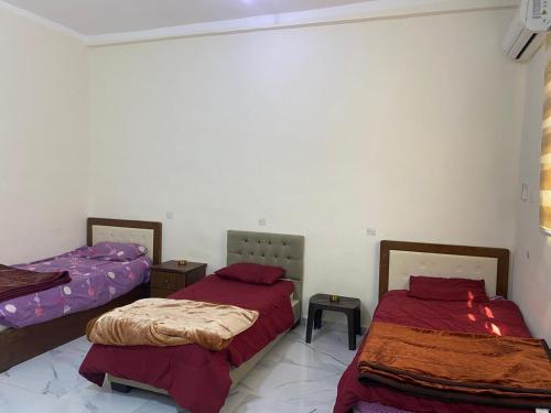 a room with two beds in a room at هوستل خدمه مبيت in Disah