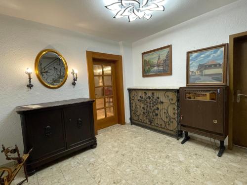 a room with a dresser and a mirror on the wall at Restaurant & Gasthaus Zur Blume in Marxzell