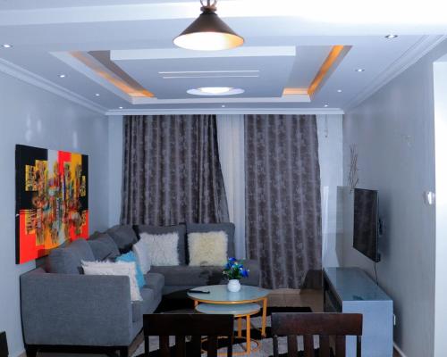 a living room with a couch and a table at Greatwall in Athi River