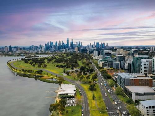 an aerial view of a city with a river and buildings at Pullman Melbourne Albert Park in Melbourne