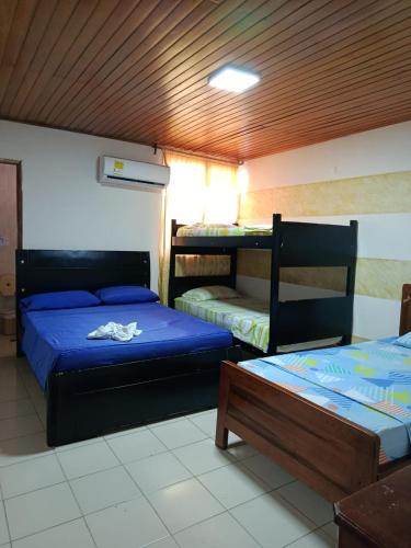 a room with two beds and two bunk beds at Hotel Colonial Inn in Barranquilla
